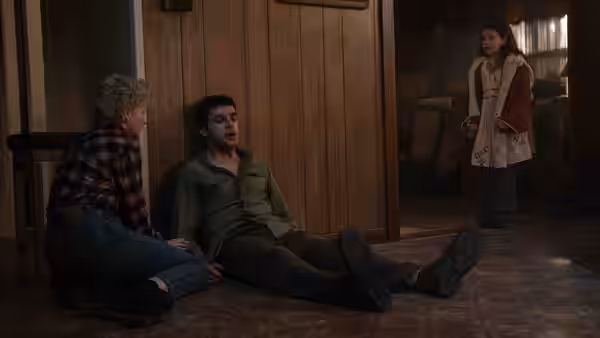 Charlotte (Julia Garner) and Blake (Christopher Abbott) on floor as Ginger watches