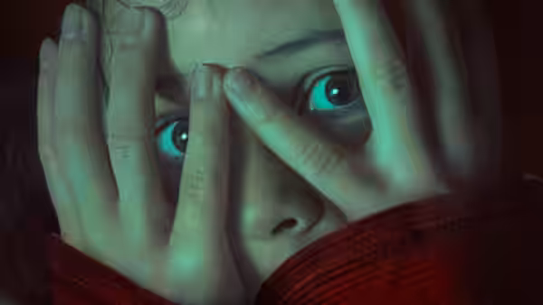 Ginger covering her face with hands in close-up
