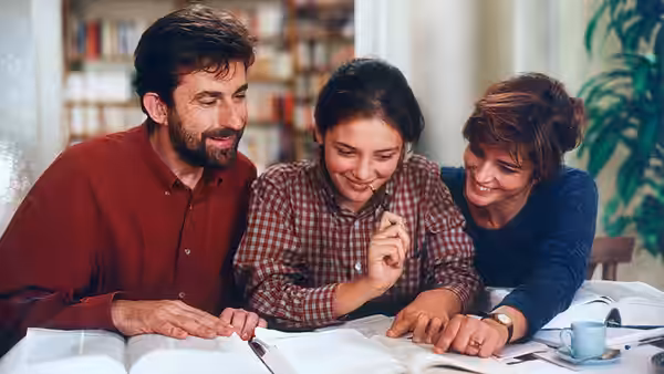 Giovanni, Irene, and Paola study together at a table