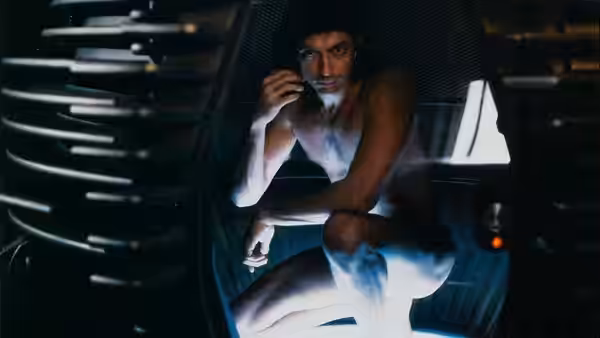 Seth Brundle (Jeff Goldblum) seated naked inside the teleportation pod