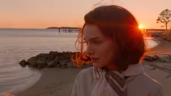 Jackie Kennedy (Natalie Portman) looks toward the water at sunset