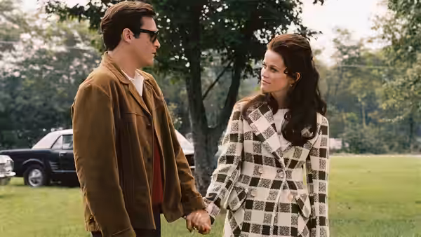 John R. Cash (Joaquin Phoenix) and June Carter (Reese Witherspoon) holding hands outdoors