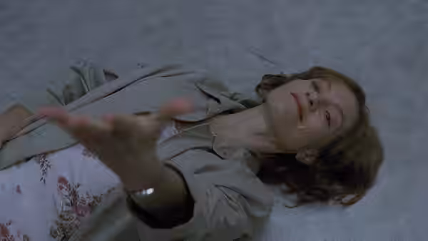 Erika's mother (Annie Girardot) lying on the floor reaching upward