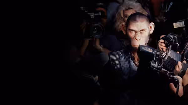 chimpanzee Robbie Williams surrounded by photographers at a media event