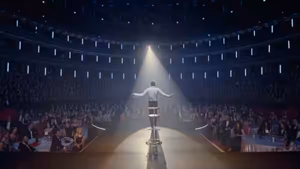 man standing on a stool with arms outstretched in a grand theater