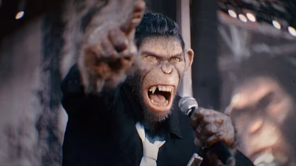 chimpanzee Robbie Williams singing into a microphone while pointing on stage