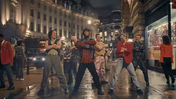 group of dancers performing a synchronized routine on a city street