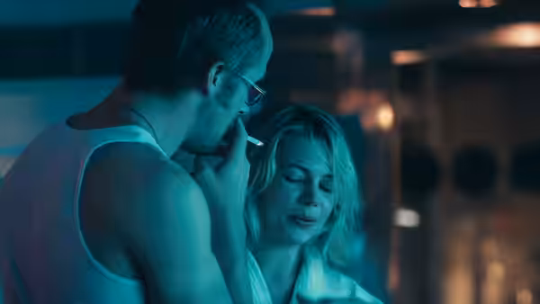 Dean (Ryan Gosling) lights a cigarette for Cindy (Michelle Williams) at night