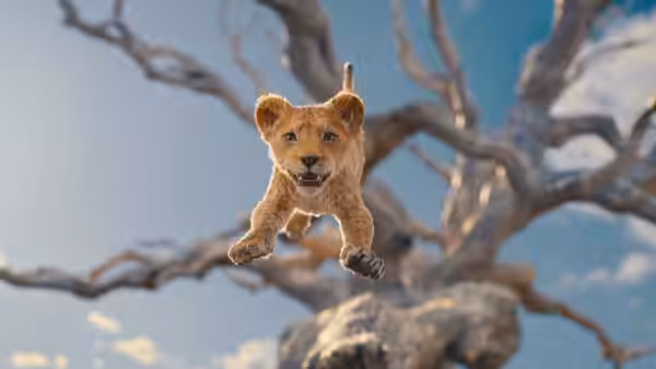 lion cub mid-leap from bare tree branches against blue sky