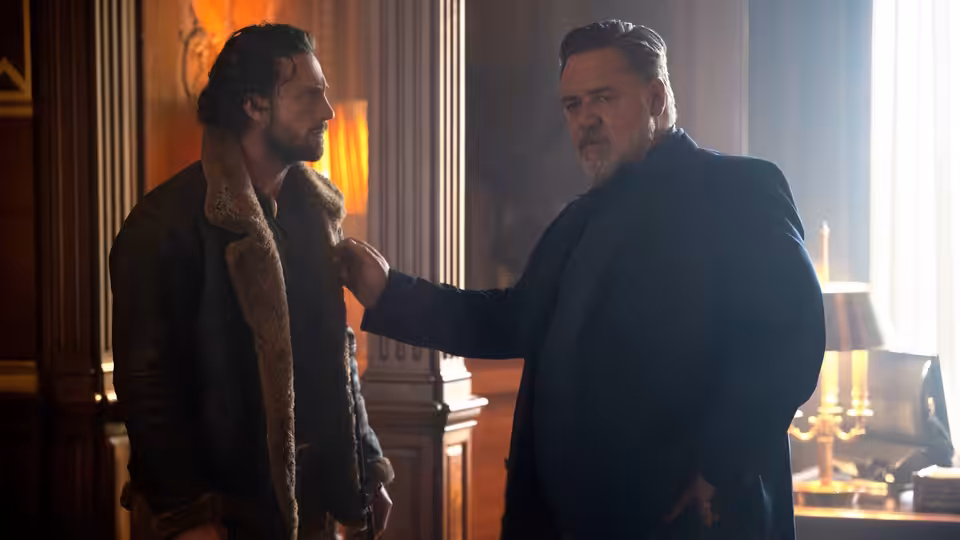Nikolai Kravinoff (Russell Crowe) with his hand on Sergei Kravinoff's shoulder in an office